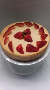 A plain cake with strawberries