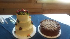 Three-tiered cake and a chocolate cake
