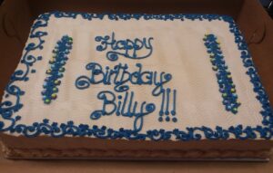 A white and blue birthday cake