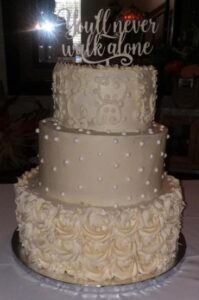 A beautiful cake with white frosting on a table