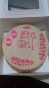 A gender reveal cake for a girl